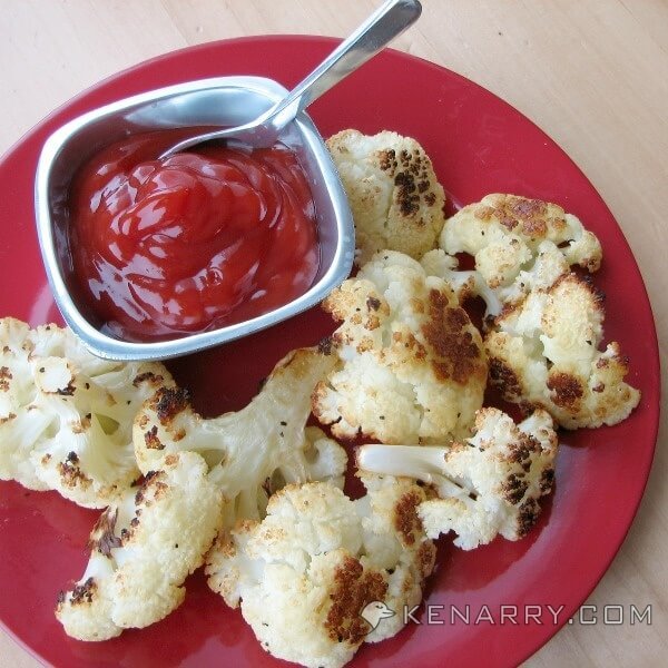 Baked Cauliflower Poppers on a red plate with ketchup
