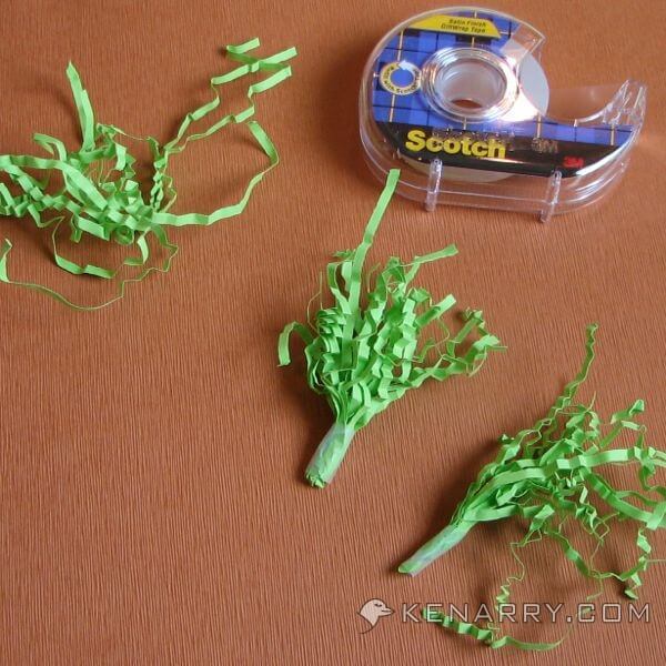 Use paper Easter grass to create carrot tops. - Kenarry.com