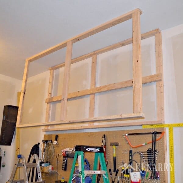 DIY Garage Storage: Great idea for ceiling mounted shelves in the garage for better seasonal storage!
