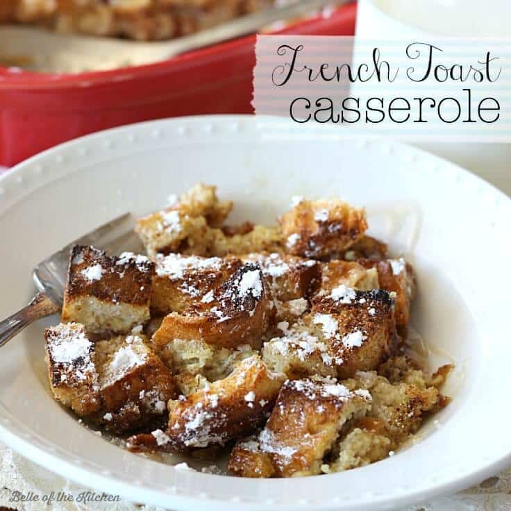 French Toast Casserole in a white bowl with powdered sugar on top