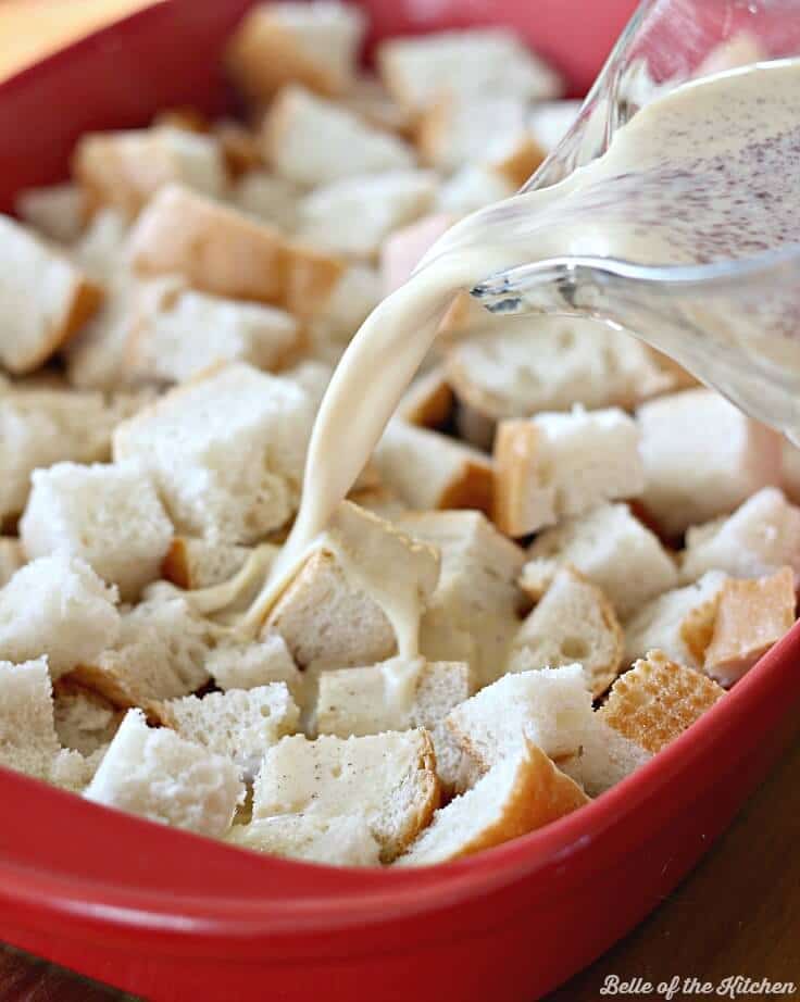 french bread cubes in a baking dish with a french toast milk mixture poured over the top