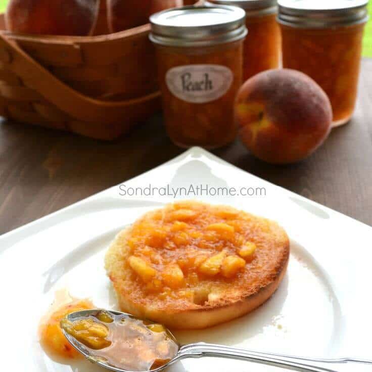 Peach Freezer Jam spread on a toasted slice of bread - - Sondra Lyn at Home.com