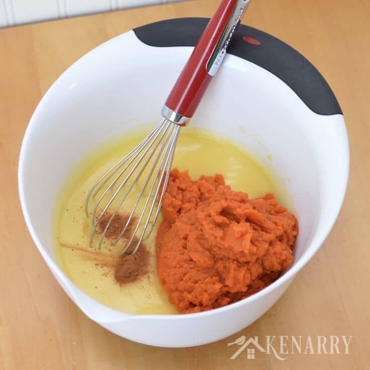 Mixing butter, spices, and pumpkin in a bowl