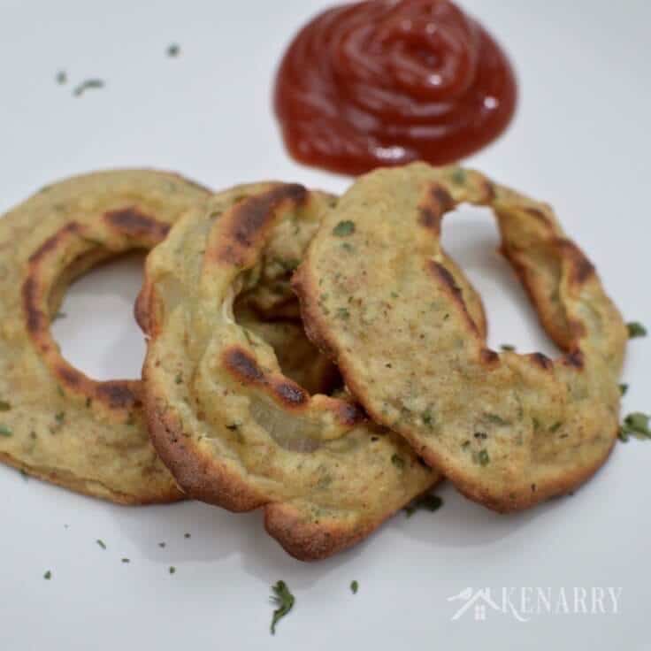 A closeup of 3 baked onion rings. 