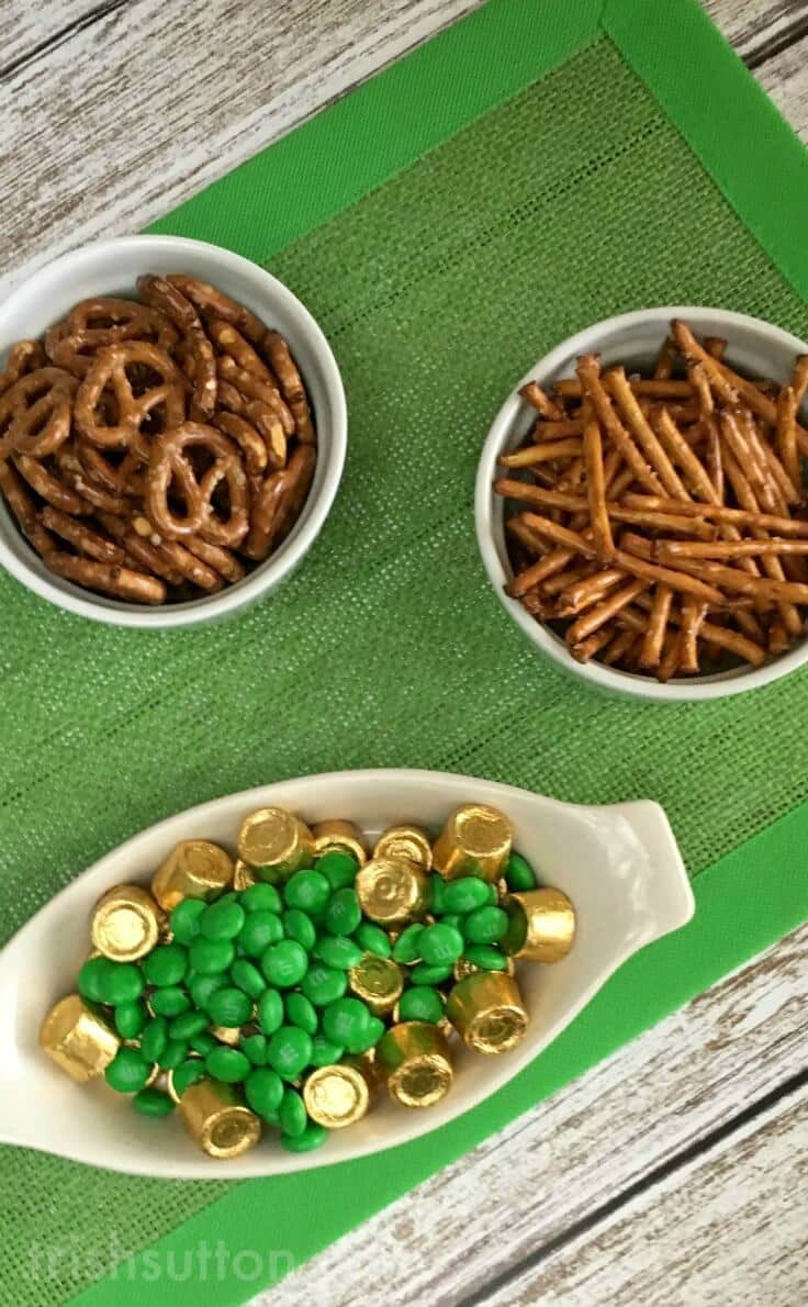 bowls of pretzels, Rolos and green M&Ms