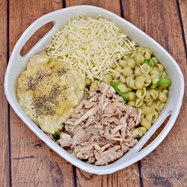This Cheesy Tuna Casserole recipe is easy to make with shell pasta and topped with crushed barbecue chips. It's a delicious idea for a weeknight meal.