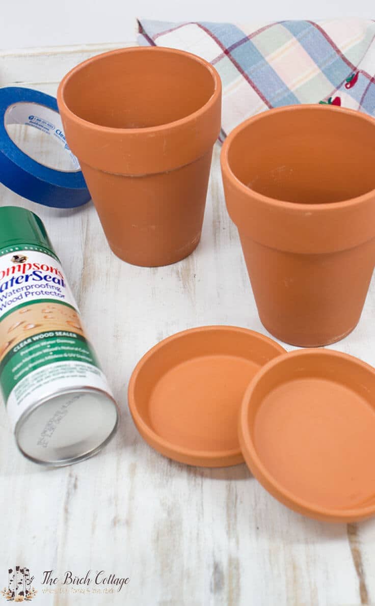 The Birch Cottage shares how to paint terra cotta pots. Turn ordinary clay pots into shabby classy pots!
