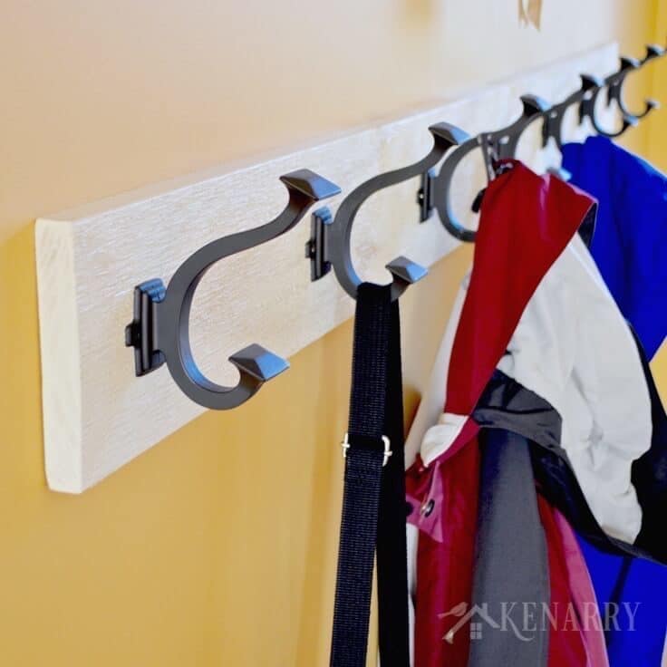 Love this idea for a DIY coat rack! It is so easy to make one yourself to hang on the wall by your front door or entry way using this step-by-step tutorial.