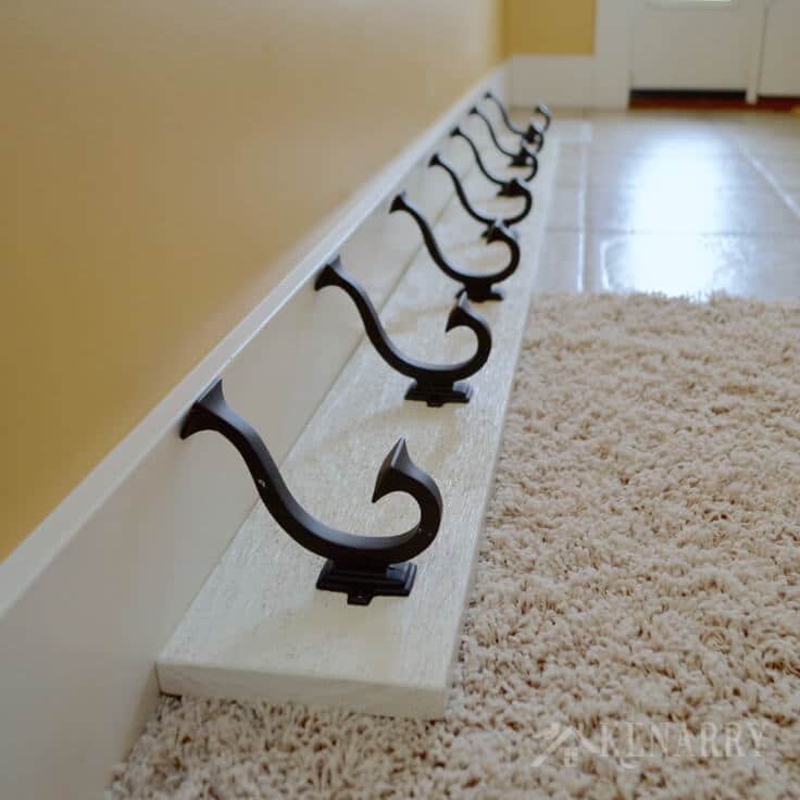 Love this idea for a DIY coat rack! It is so easy to make one yourself to hang on the wall by your front door or entry way using this step-by-step tutorial.