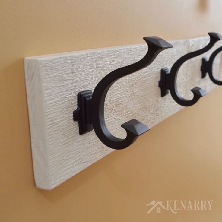 A close up of decorative hooks for a coat rack
