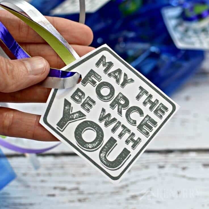 Tying May the Force Be With You gift tags with metallic ribbons