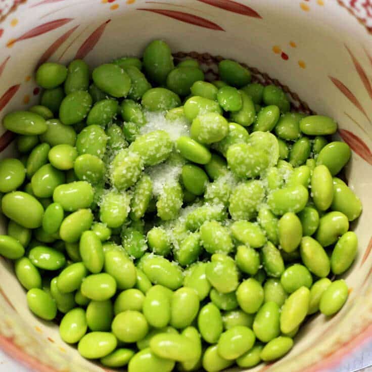 Shelled edamame in a bowl with salt