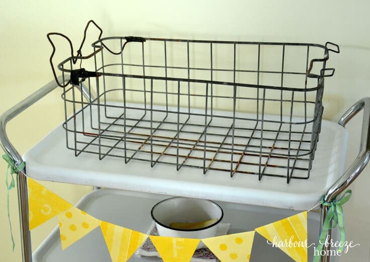 Turn a rusty old basket into a pretty industrial decor piece using spray paint and fabric. This easy tutorial will show you how!