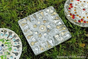 Mosaic stepping stones are a perfect summer craft. Gather flea market finds like keys and coins, then embed them in concrete. Great craft with kids!