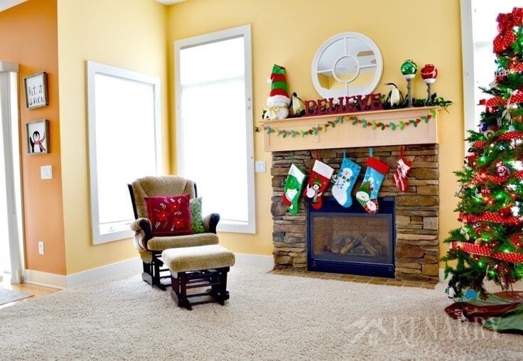 Love these Christmas mantel decor ideas to update a fireplace for the holidays with bright red and festive green accents! These easy ideas will have your living room ready for hosting holiday parties and all the fun events of the season.