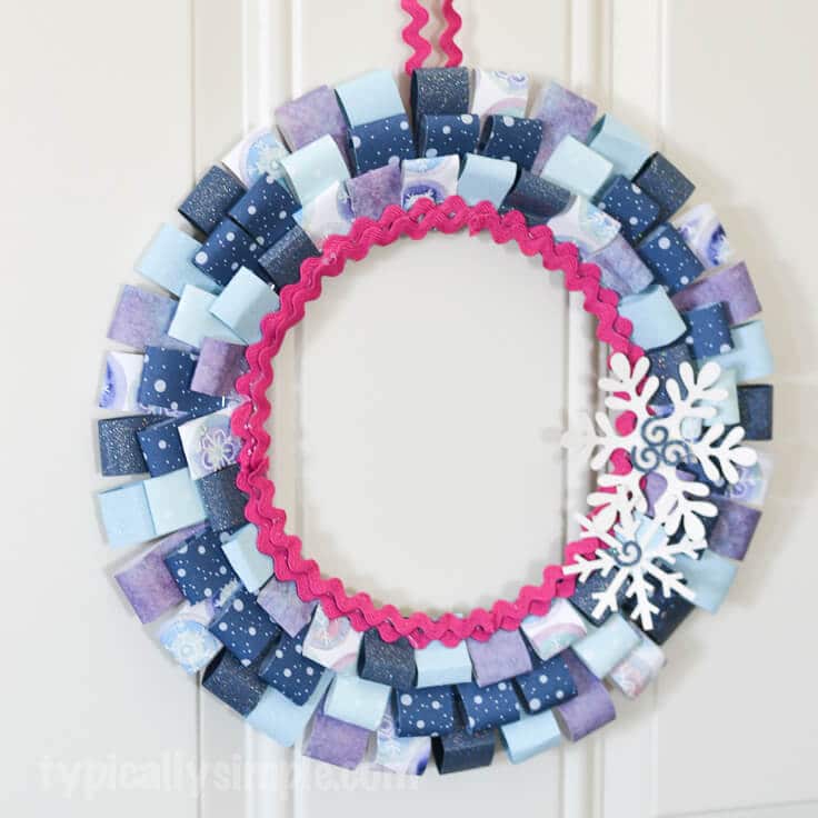 With just a few basic craft supplies and some paper from your scrapbooking stash, make this paper wreath to decorate your home for winter!