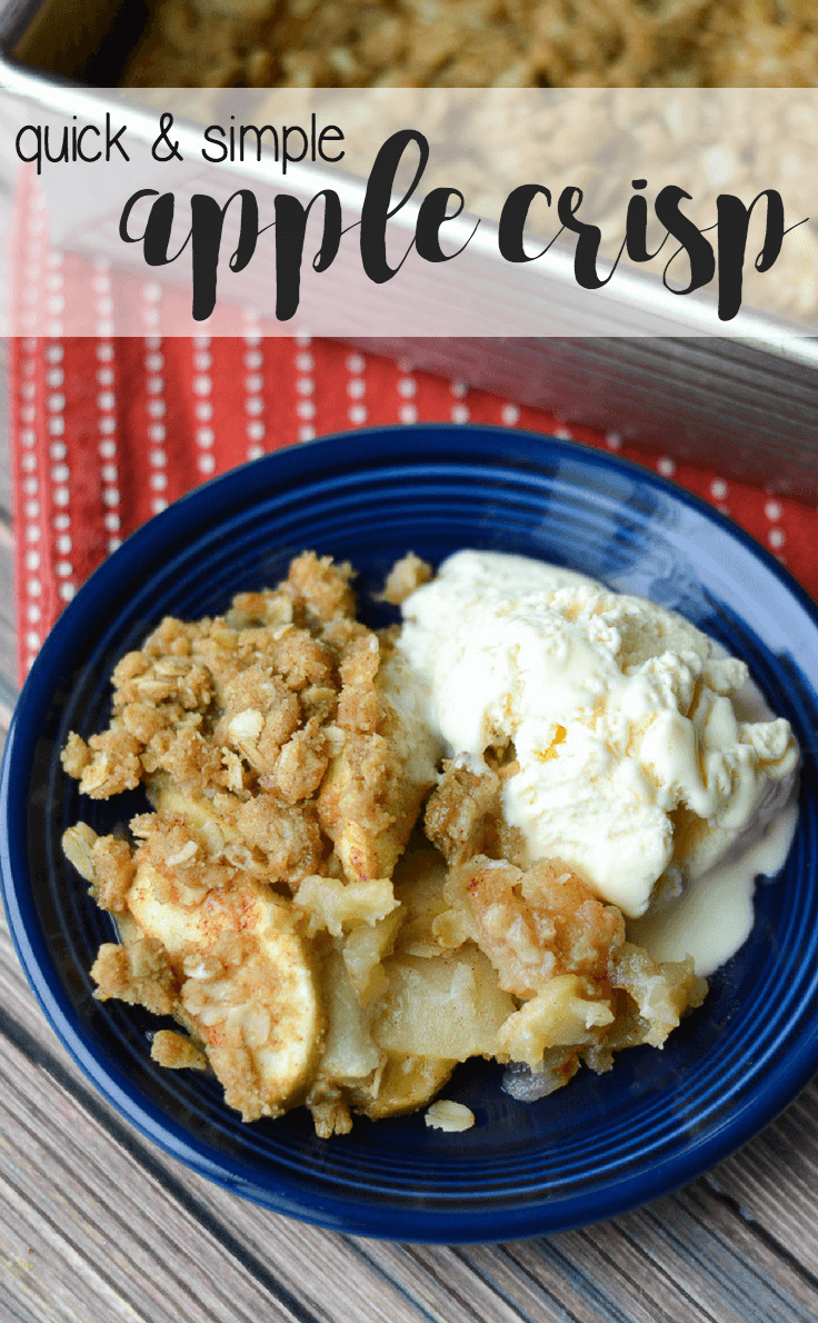 apple crisp in a bowl with vanilla ice cream on a wooden surface