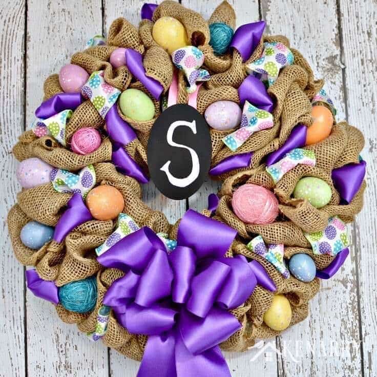 What a pretty craft idea for an Easter wreath! The burlap ribbon gives it a rustic look -- and the Easter eggs and bright purple accents make it look so fun and festive to decorate my home for spring.
