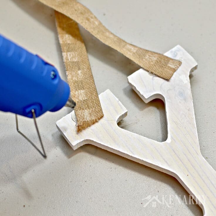 hot gluing ribbon to the wooden letter