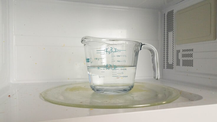 A cup of water inside the microwave