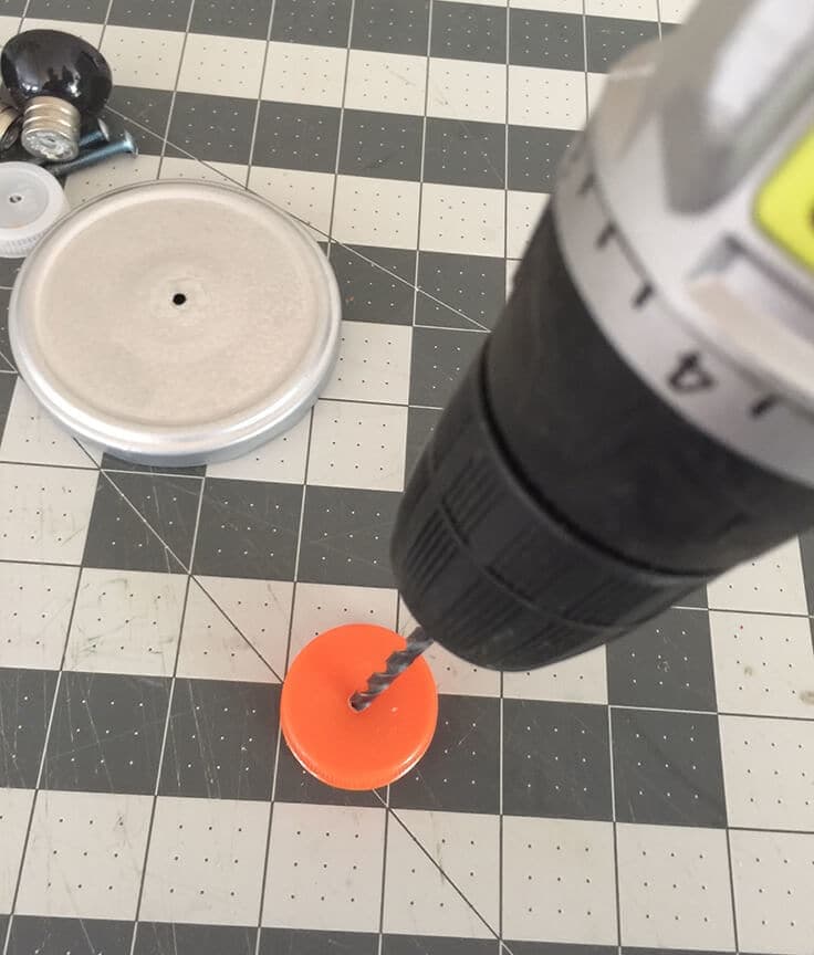 Drilling a hole into a plastic cap.