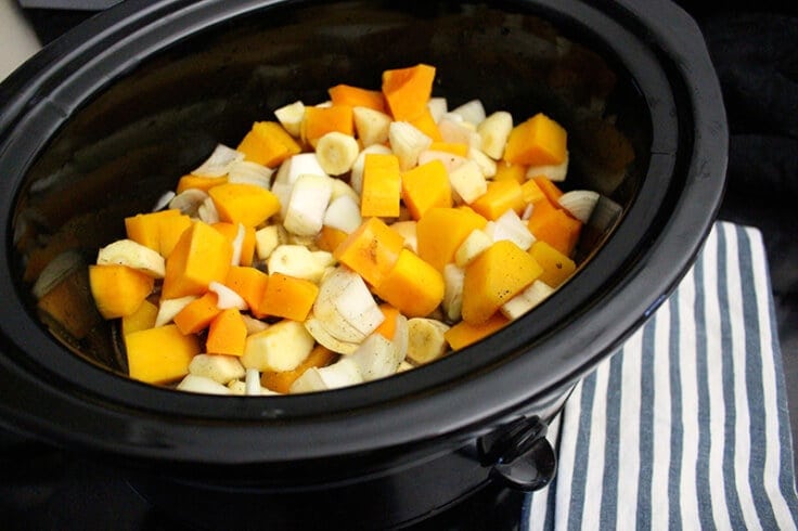 Parsnips, butternut squash, and onions in a slow cooker 