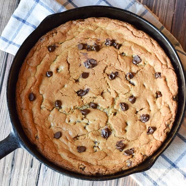 A huge chocolate chip cookie in a skillet