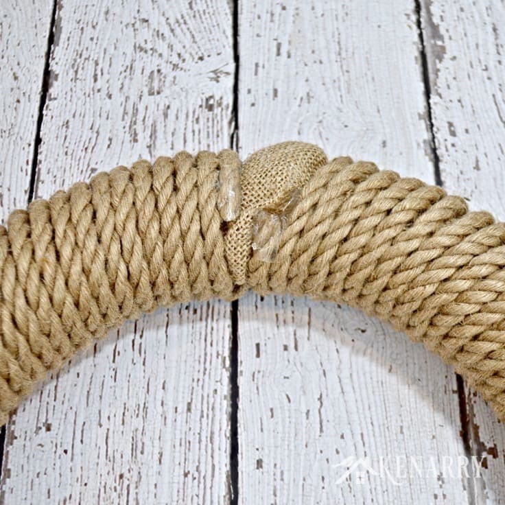 A gap in the rope and burlap on a wreath 