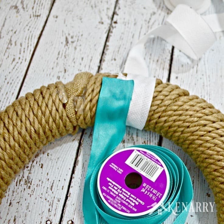 wrapping a sisal rope wreath with blue and white ribbon
