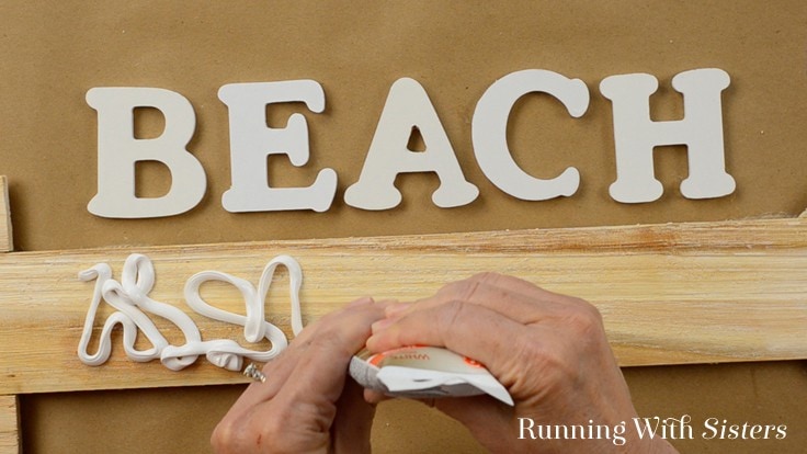 Make a beachy mosaic arrow sign without grout. We'll show you how to add sea glass, crushed shells, and sand to make an easy mosaic BEACH sign!
