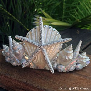 Make your own seashell mermaid crown! Start with an inexpensive tiara and use it as a canvas for scallop shells, starfishes, and conchs. Finish with gems!