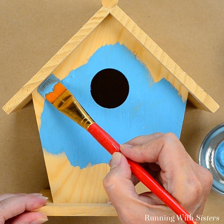 Painting the front of a birdhouse ocean blue