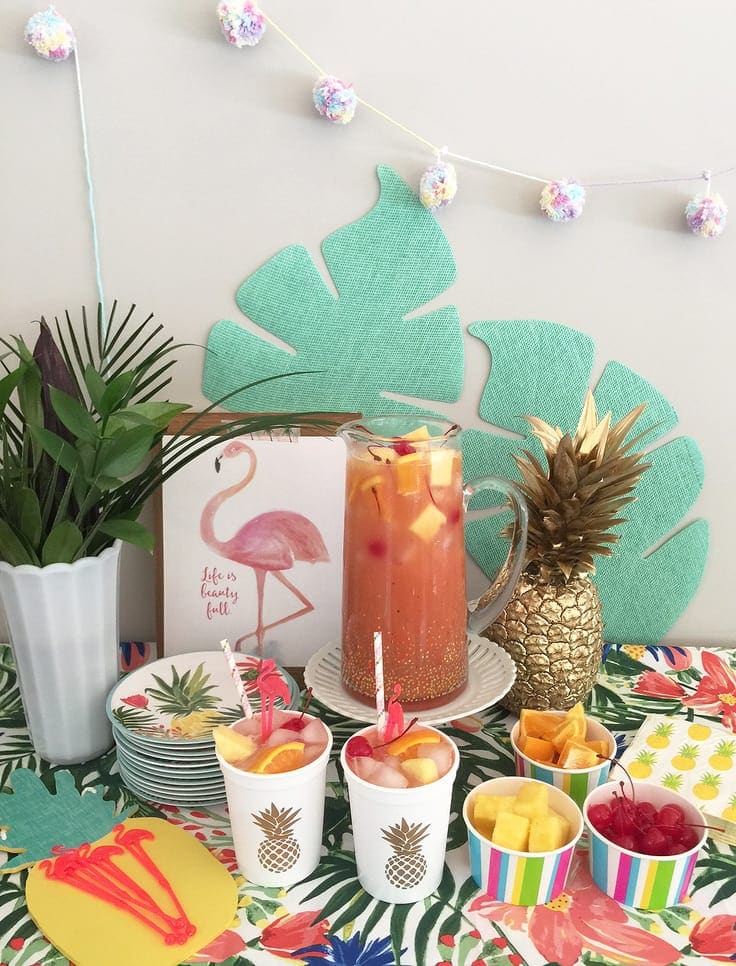 This trendy summer pink fruit punch is a fun, easy-to-make non-alcoholic beverage. It's perfect for a kid's luau birthday party, or add some rum for an adult-only alcoholic drink. #summercocktail #drinks #kenarry