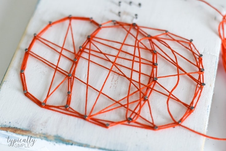 This pumpkin string art project is such a simple craft to make and will add the perfect pop of fall to your table or mantel!