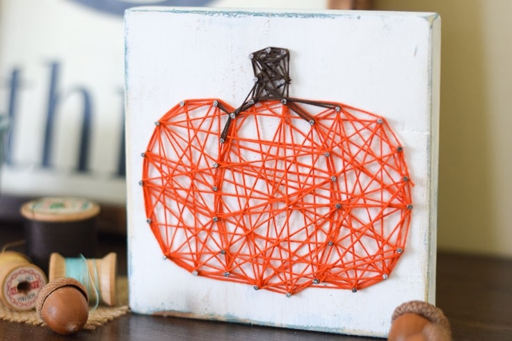 This pumpkin string art project is such a simple craft to make and will add the perfect pop of fall to your table or mantel!