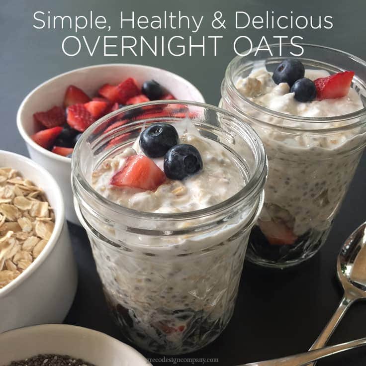 overnight oats in mason jars topped with strawberries and blueberries