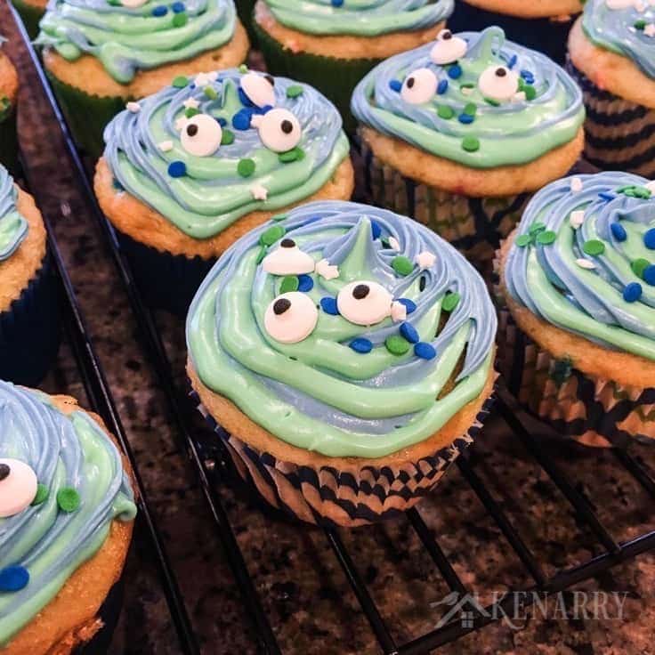 Blue and green swirl frosting with festive sprinkles and candy eyes make cute alien or monster cupcakes for a birthday party or Halloween treat.