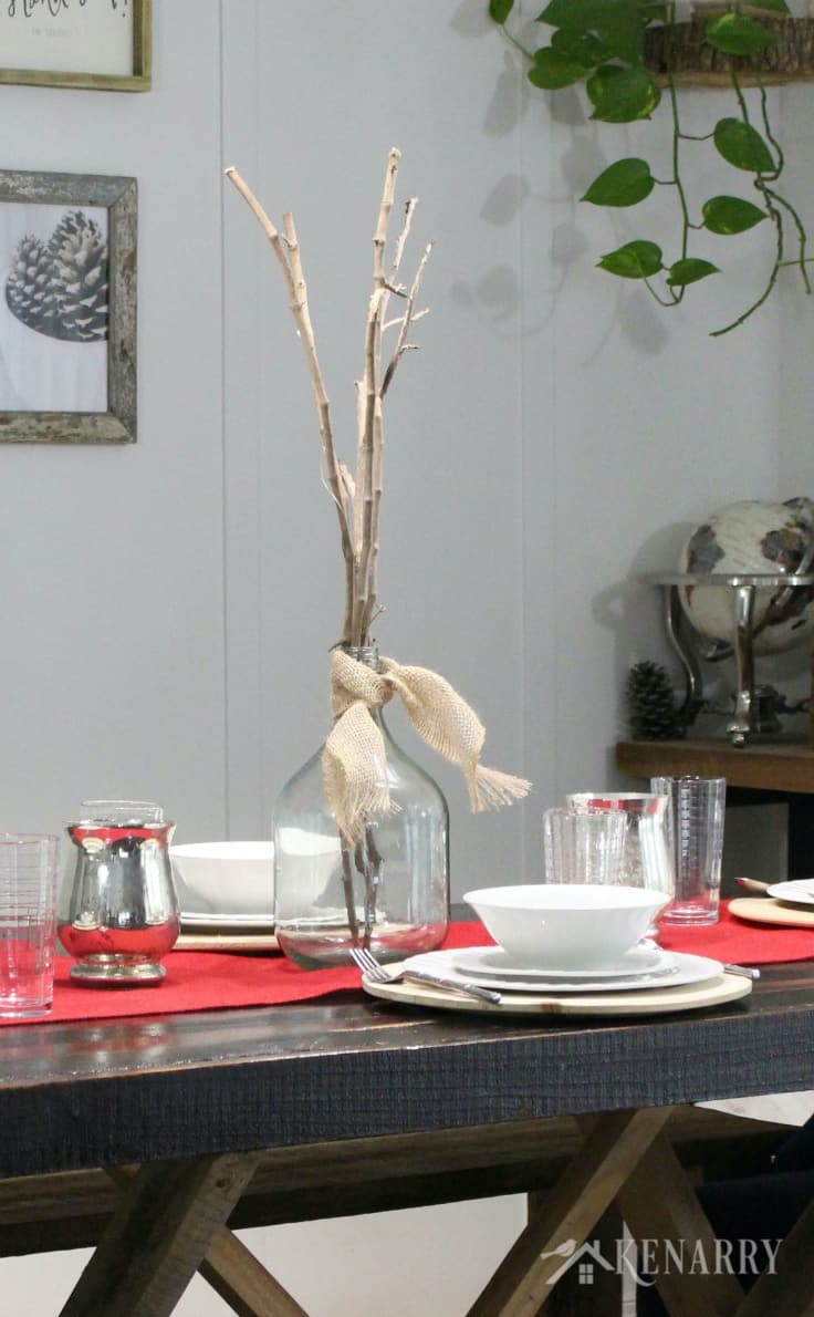Put long sticks in a large clear glass vase as a centerpiece this holiday season. As Thanksgiving table decor, this simple stylish centerpiece adds just the right amount of height and drama to your dinner table. Throw in a red burlap table runner for added texture.