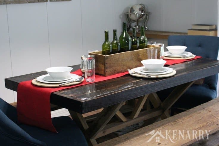 Use simple white dishes for holiday dinners. Add a wood planter box filled with empty wine bottles as your centerpiece on a red burlap table runner for your Thanksgiving table decor if you love farmhouse style decorating in your home.