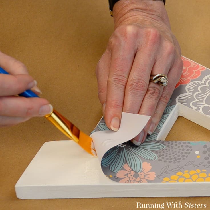 Decoupage a letter to give as a handmade gift! We'll show you how to decorate a craft store letter with scrapbook paper and Mod Podge.