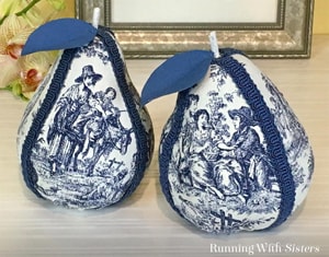 Turn inexpensive pears into Fabric Covered Toile Pears using Mod Podge and fabric! Just cover them with fabric and gimp trim. Pretty DIY home accent!