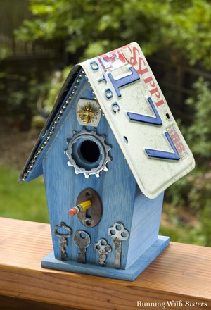 Turn a plain birdhouse into a Flea Bitten Embellished Birdhouse with skeleton keys, a bicycle gear, a rusty keyhole, and more!