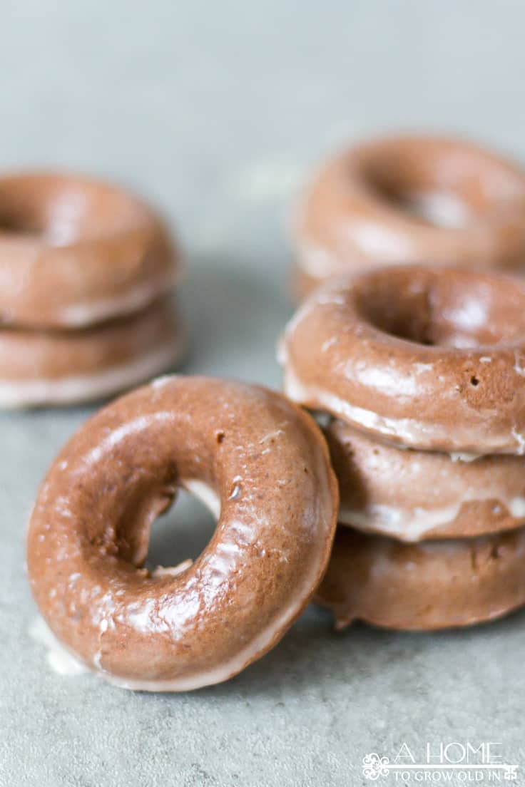 These delicious baked chocolate glazed donuts are a lightened up version of the fried variety but your sweet tooth will never know it.