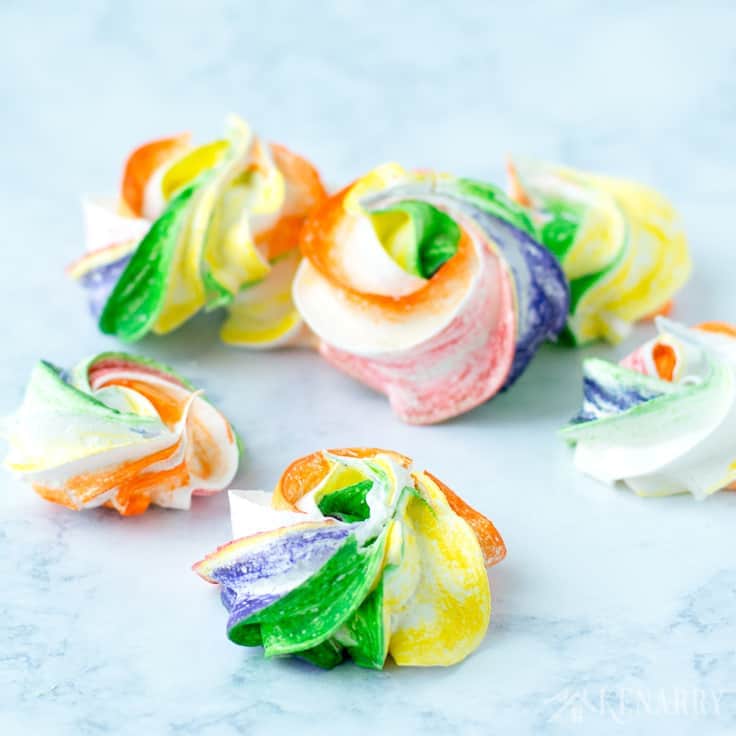 rainbow meringue cookies on a marble surface