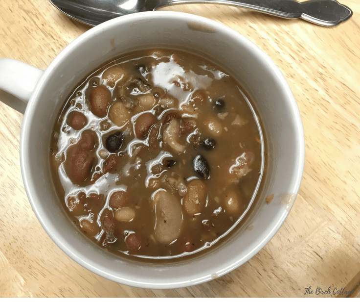 Learn how to make this healthy Instant Pot Ham Bone and 15 Bean Soup recipe! Nothing warms you up on those cold fall or winter nights quite like a bowl of hearty, homemade mixed bean soup, especially when you can make it in about an hour in your Instant Pot or electric pressure cooker. #soup #instantpot #kenarry