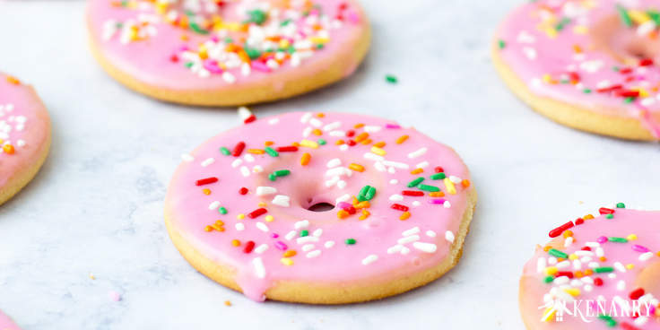 Create a fun dessert with the kids using this easy recipe for frosted Donut Cookies made from sugar cookie dough. Topped with sprinkles, these cookies are a great party treat!
