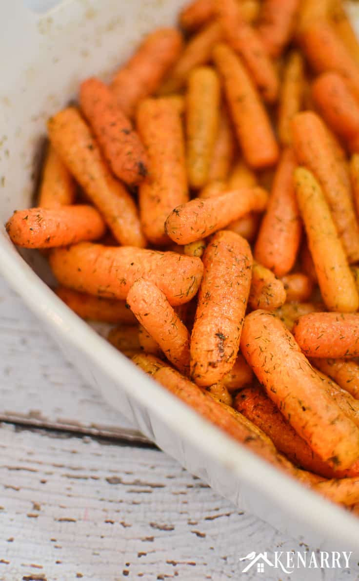 roasted carrots with dill in a white baking dish