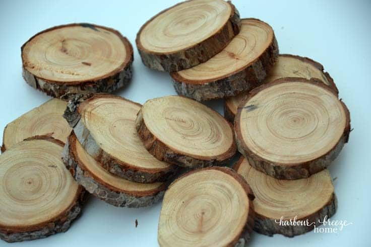 Pile of wood slices made out of branches sitting on a white table