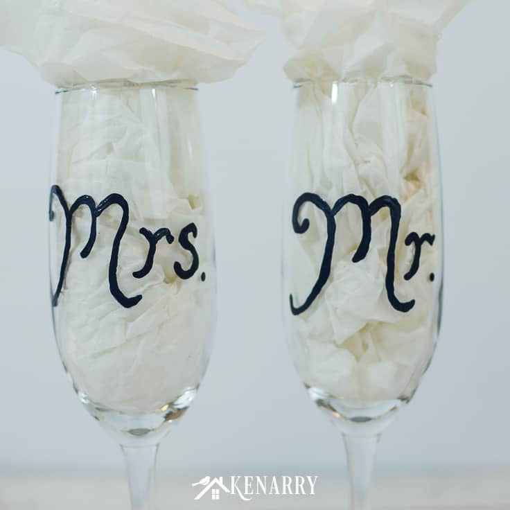 These Mr. and Mrs. toasting glasses are an easy DIY gift for the bride and groom, perfect for a bridal shower, wedding or anniversary. Learn how to paint champagne flutes. #weddinggifts #weddingideas #weddingreception #handpainted