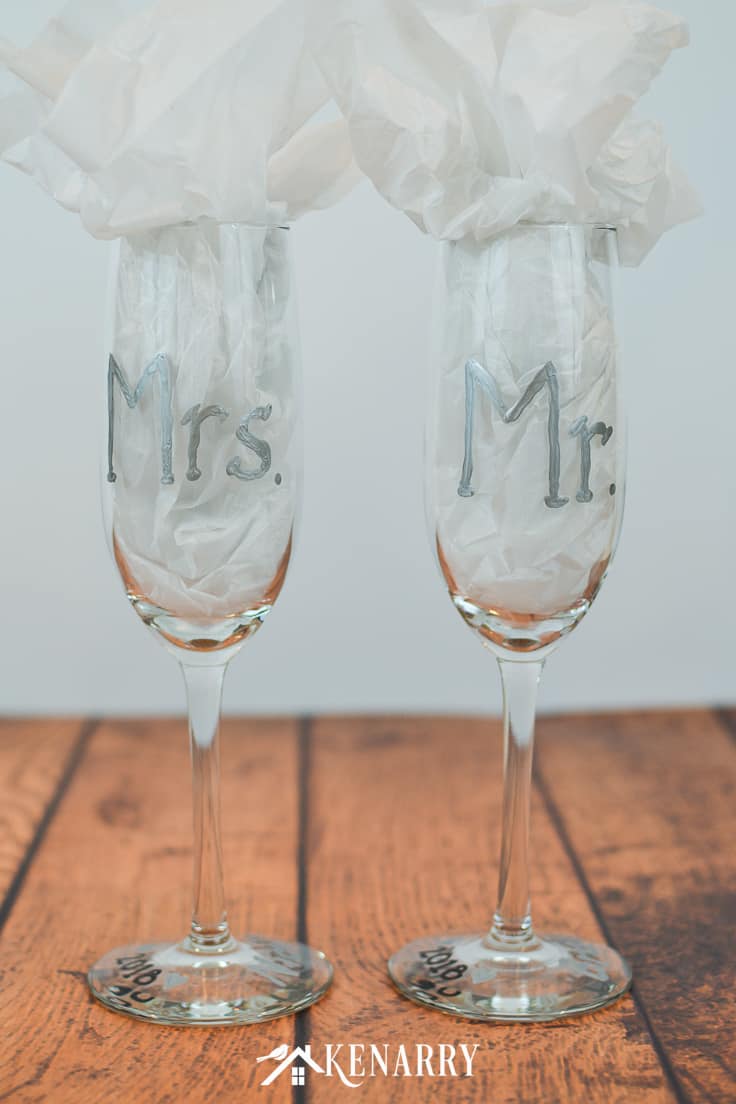 Got a friend who's getting married? Surprise her with personalized hand painted champagne glasses. These Mr. and Mrs. toasting glasses are an easy DIY gift for the bride and groom. Champagne flutes are perfect for a bridal shower, wedding or anniversary. #weddinggifts #weddingideas #weddingreception #handpainted